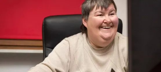 Frau mit einer Behinderung bedient einen PC